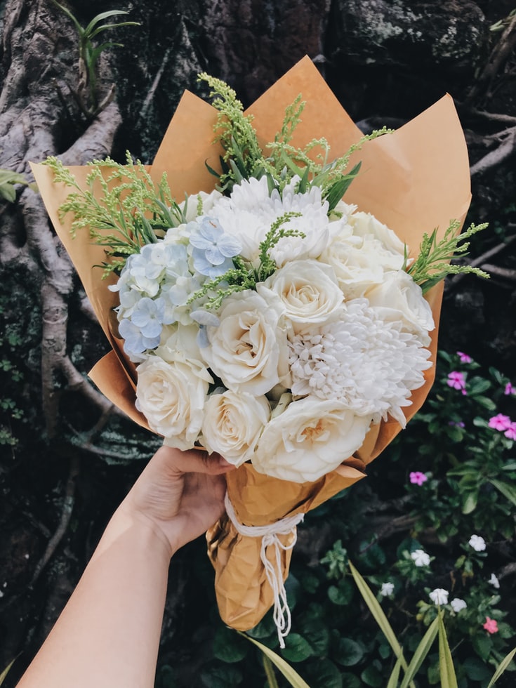 holding flower bouquet